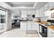 Bright kitchen with white cabinets, wood countertops, and a sliding door to the patio at 13228 E Asbury Dr, Aurora, CO 80014