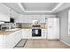 Well-lit kitchen featuring white appliances, cabinets, and a neutral color scheme at 13228 E Asbury Dr, Aurora, CO 80014