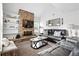 Comfortable living room with stone fireplace, seating and shelves perfect for entertaining and relaxing at 13228 E Asbury Dr, Aurora, CO 80014
