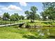 Picturesque view of the golf course pond with a bridge and manicured landscaping at 13228 E Asbury Dr, Aurora, CO 80014