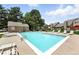 Community pool area with lounge chairs, shade trees, and a cabana-style building at 13228 E Asbury Dr, Aurora, CO 80014