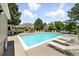 Large community pool surrounded by lounge chairs, tables and chairs, and buildings beyond at 13228 E Asbury Dr, Aurora, CO 80014