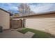 Fenced backyard with patch of artificial turf, patio and entrance door to the home at 3593 S Kittredge St # E, Aurora, CO 80013