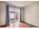 Bright bedroom featuring sliding glass doors leading to the outside at 3593 S Kittredge St # E, Aurora, CO 80013