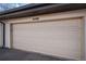 Attached garage with cream door and house address at 3593 S Kittredge St # E, Aurora, CO 80013