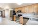 Well-lit kitchen offering stainless steel appliances and open access to the living area at 3593 S Kittredge St # E, Aurora, CO 80013