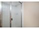 Enclosed glass shower with metal door in neutral colored bathroom at 3593 S Kittredge St # E, Aurora, CO 80013