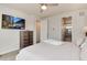 Comfortable bedroom with mounted TV and en-suite bathroom at 2615 Mayotte Way, Castle Rock, CO 80109