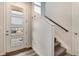 Modern entryway with glass door and carpeted staircase at 2615 Mayotte Way, Castle Rock, CO 80109