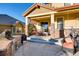 Spacious back patio with stone pillars, outdoor seating, grill, and lush landscaping at 10480 Skyreach Rd, Highlands Ranch, CO 80126