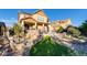 Beautiful backyard features a stone patio, manicured lawn, and mature landscaping at 10480 Skyreach Rd, Highlands Ranch, CO 80126