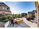 Outdoor patio with fire pit and grill surrounded by seating, grass and lush landscaping at 10480 Skyreach Rd, Highlands Ranch, CO 80126