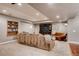 Finished basement featuring a large sectional sofa and media console at 10480 Skyreach Rd, Highlands Ranch, CO 80126