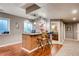 Finished basement bar area with granite countertops, wood floors, and adjacent bathroom at 10480 Skyreach Rd, Highlands Ranch, CO 80126