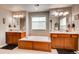Relaxing bathroom with a soaking tub, dual sinks, and elegant lighting at 10480 Skyreach Rd, Highlands Ranch, CO 80126