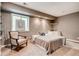Cozy bedroom with neutral tones, plush carpeting, and a comfortable chair by the window at 10480 Skyreach Rd, Highlands Ranch, CO 80126