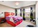 Cozy bedroom with colorful curtains, carpeted floor, and a comfortable bed at 10480 Skyreach Rd, Highlands Ranch, CO 80126