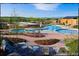 Community pool and clubhouse surrounded by lush landscaping and lounge chairs at 10480 Skyreach Rd, Highlands Ranch, CO 80126