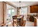 Bright dining area with sliding glass doors leading to an outdoor patio, and stylish light fixture at 10480 Skyreach Rd, Highlands Ranch, CO 80126