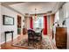Elegant dining room with tray ceilings, hardwood floors, and stylish chandelier at 10480 Skyreach Rd, Highlands Ranch, CO 80126