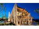 Modern home with stone accents, large windows, outdoor seating area, and lush landscaping at 10480 Skyreach Rd, Highlands Ranch, CO 80126