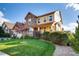 Charming two-story home with well-manicured lawn, stone accents, and beautiful landscaping at 10480 Skyreach Rd, Highlands Ranch, CO 80126