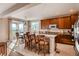 Open kitchen with granite countertops, a breakfast bar, and adjacent dining area overlooking mountain views at 10480 Skyreach Rd, Highlands Ranch, CO 80126
