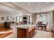 Open concept kitchen flowing into the living room, featuring stainless steel appliances and a breakfast bar at 10480 Skyreach Rd, Highlands Ranch, CO 80126