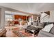 Open concept living space with hardwood flooring, a cozy couch, and a staircase at 10480 Skyreach Rd, Highlands Ranch, CO 80126