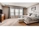 Bright main bedroom with large windows, plush carpet, and a comfortable king bed at 10480 Skyreach Rd, Highlands Ranch, CO 80126