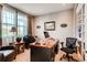 Bright home office with built-in bookshelves, a large window, and comfortable furnishings at 10480 Skyreach Rd, Highlands Ranch, CO 80126