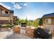 Backyard with built-in stone kitchen and stainless steel grill for outdoor cooking at 10480 Skyreach Rd, Highlands Ranch, CO 80126