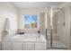 Relaxing bathroom with a soaking tub, separate shower, and natural light from a window at 16706 E Black Horn Dr, Parker, CO 80134