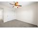 A carpeted bedroom with a ceiling fan and a sliding door closet at 16706 E Black Horn Dr, Parker, CO 80134