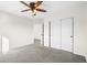 A carpeted bedroom with a ceiling fan and a sliding door closet at 16706 E Black Horn Dr, Parker, CO 80134