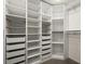 Organized walk-in closet with adjustable shelving, drawers, and baskets for ample storage at 16706 E Black Horn Dr, Parker, CO 80134