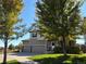 Inviting two-story home with a three-car garage and mature trees providing shade at 16706 E Black Horn Dr, Parker, CO 80134