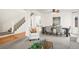 Open-concept living area with hardwood floors, staircase, and a dining space at 16706 E Black Horn Dr, Parker, CO 80134