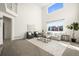 Spacious living room with high ceilings, large windows, and stylish furnishings at 16706 E Black Horn Dr, Parker, CO 80134