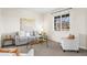 Cozy living room with neutral tones, comfortable seating, and a large window at 16706 E Black Horn Dr, Parker, CO 80134
