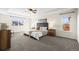 Spacious primary bedroom featuring a tray ceiling, large windows, and neutral decor at 16706 E Black Horn Dr, Parker, CO 80134