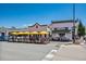 Charming restaurant exterior with outdoor patio seating under bright yellow umbrellas at 645 Flintwood Place, Lafayette, CO 80026