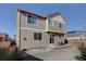 Two-story home exterior showing the tan siding, patio, and grass lawn at 3164 S Kirk Way, Aurora, CO 80013