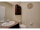 Powder room with a decorative shelf, flower art, toilet and granite vanity top at 3164 S Kirk Way, Aurora, CO 80013