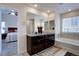 Bathroom featuring double vanity with granite counters and separate tub at 3164 S Kirk Way, Aurora, CO 80013