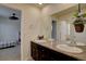 Bathroom featuring a double vanity with granite countertop and decorative hanging plant at 3164 S Kirk Way, Aurora, CO 80013