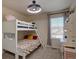 Bedroom features a bunk bed, ceiling fan, and neutral carpeting at 3164 S Kirk Way, Aurora, CO 80013
