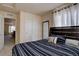 Comfortable bedroom with large window, carpet floor, closet, and a decorative mirror at 3164 S Kirk Way, Aurora, CO 80013