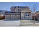 Charming two-story home featuring a stone facade, three-car garage, and solar panels, perfect for suburban living at 3164 S Kirk Way, Aurora, CO 80013