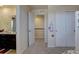Hallway with closet and bathroom entrance with neutral finishes and carpeting at 3164 S Kirk Way, Aurora, CO 80013